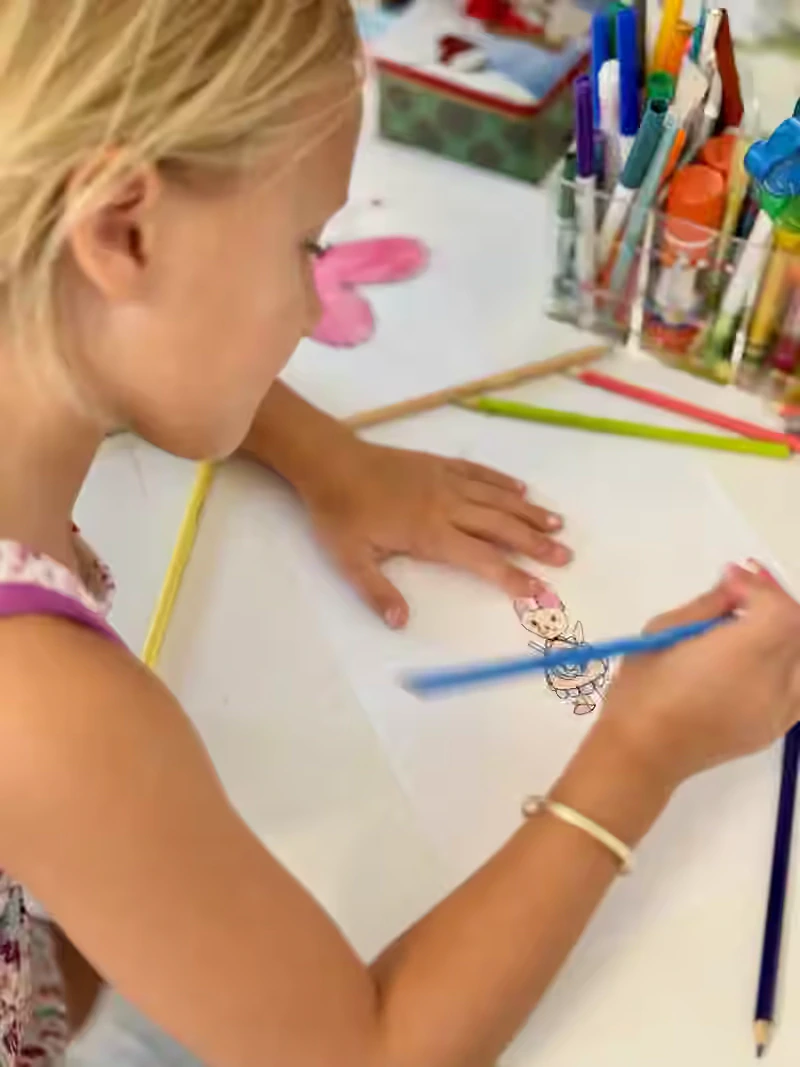 Brooklyn drawing at the worktable.